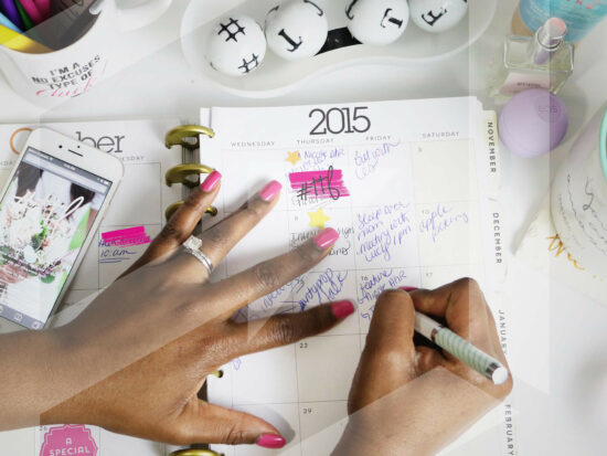 Woman's hand marking a date in an agenda